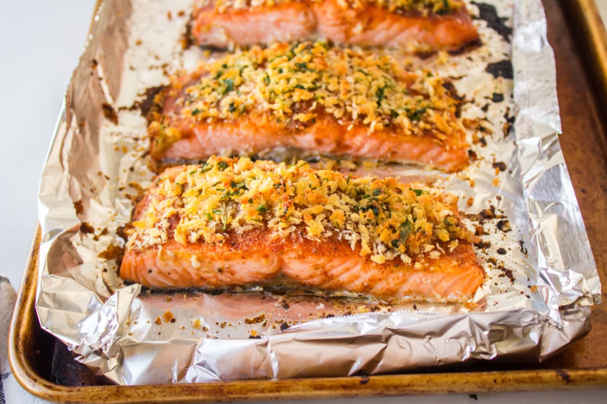 Easy Baked Salmon with a crispy breadcrumb topping and sweet savory flavor. A quick and delicious salmon dinner ready in minutes. easy baked salmon on a baking sheet