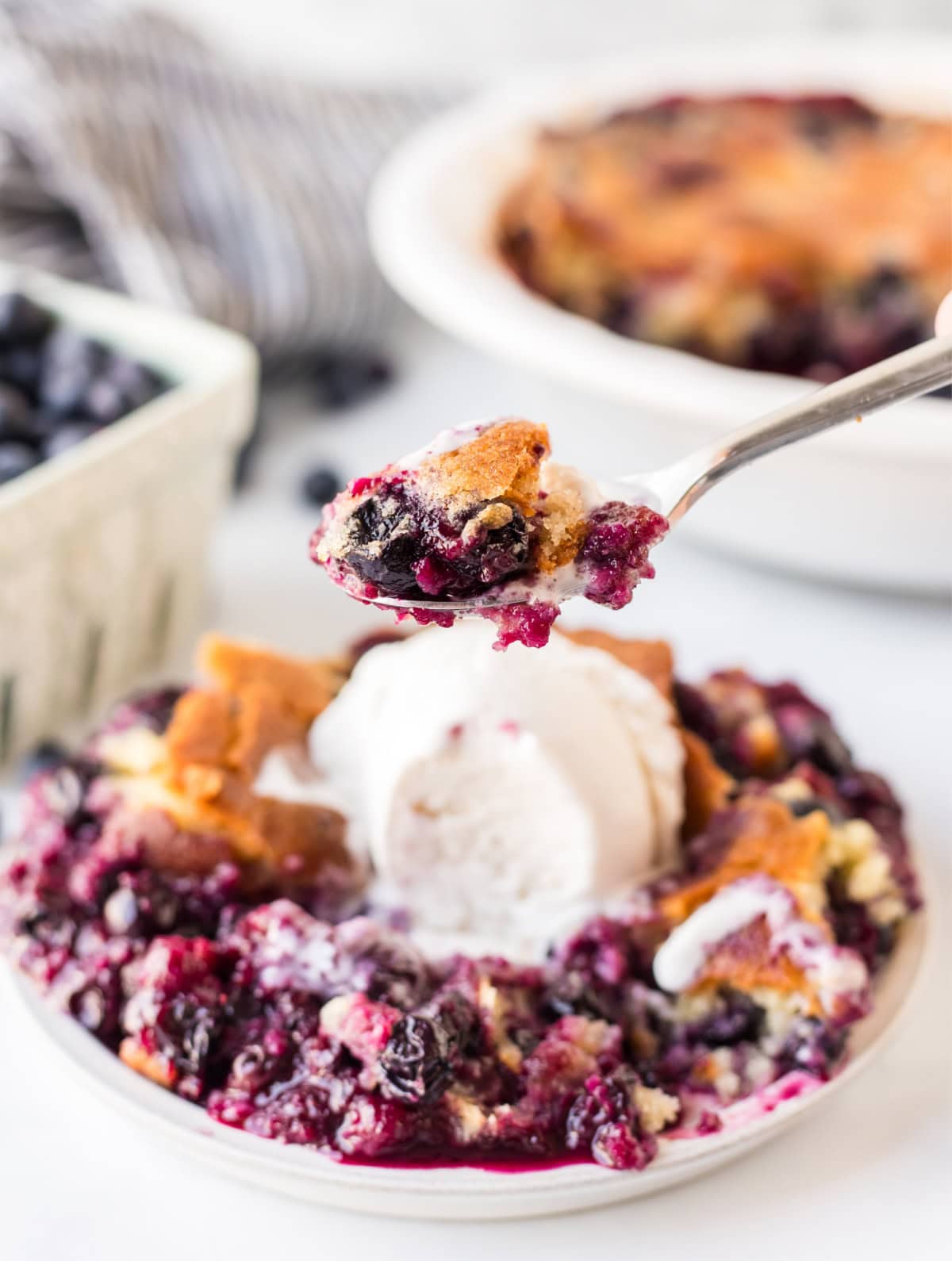 fork full of blueberry cobbler