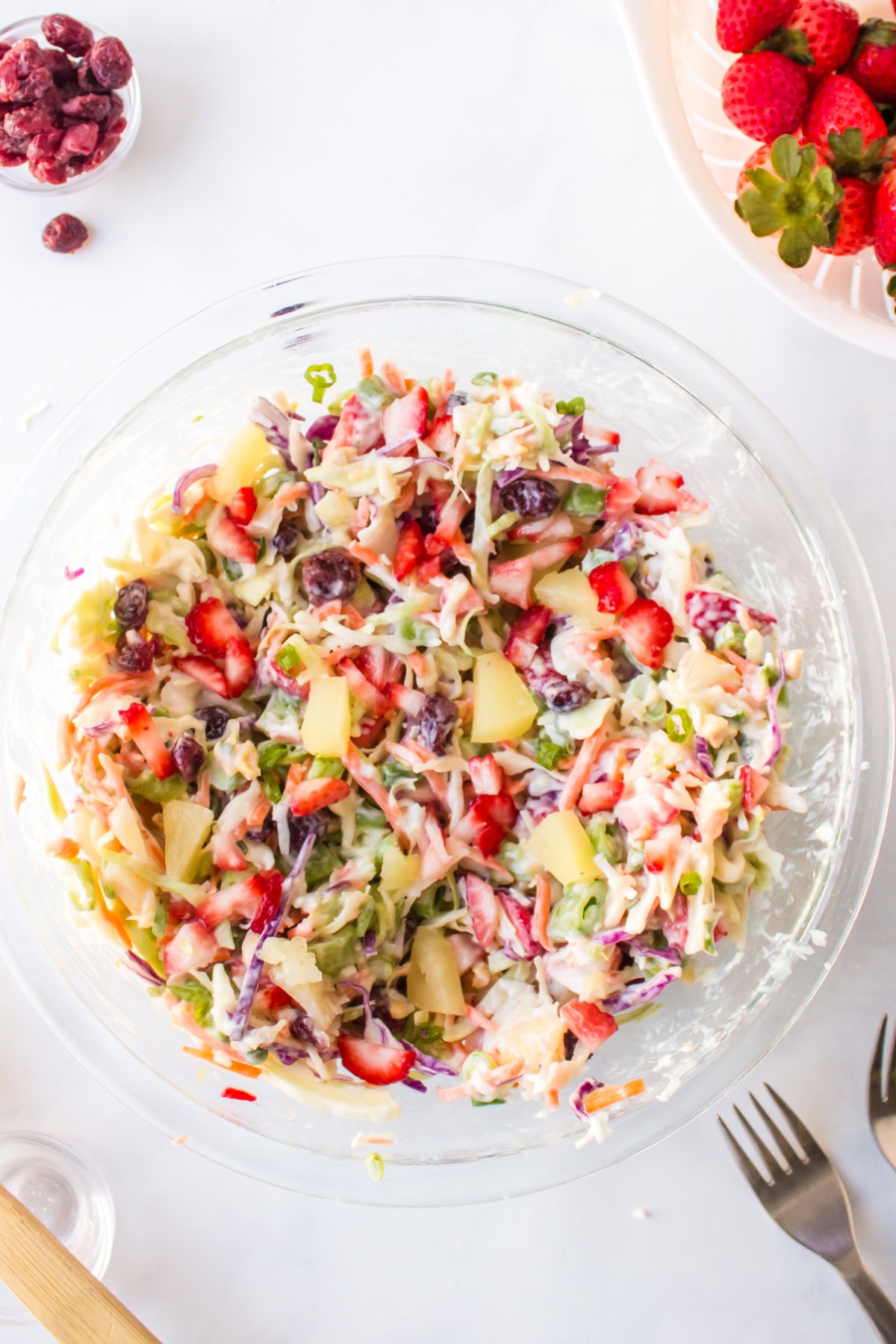 Fruity Coleslaw with strawberries, pineapple and coconut is a sweet, tangy and crunchy side dish perfect for BBQs and summer gatherings. bowl of fruity coleslaw