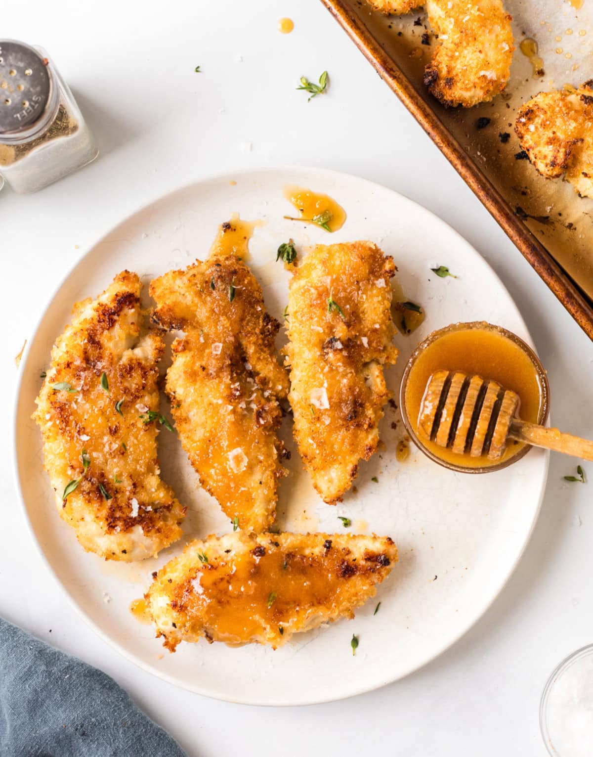 hot honey drizzled chicken tenders on a plate