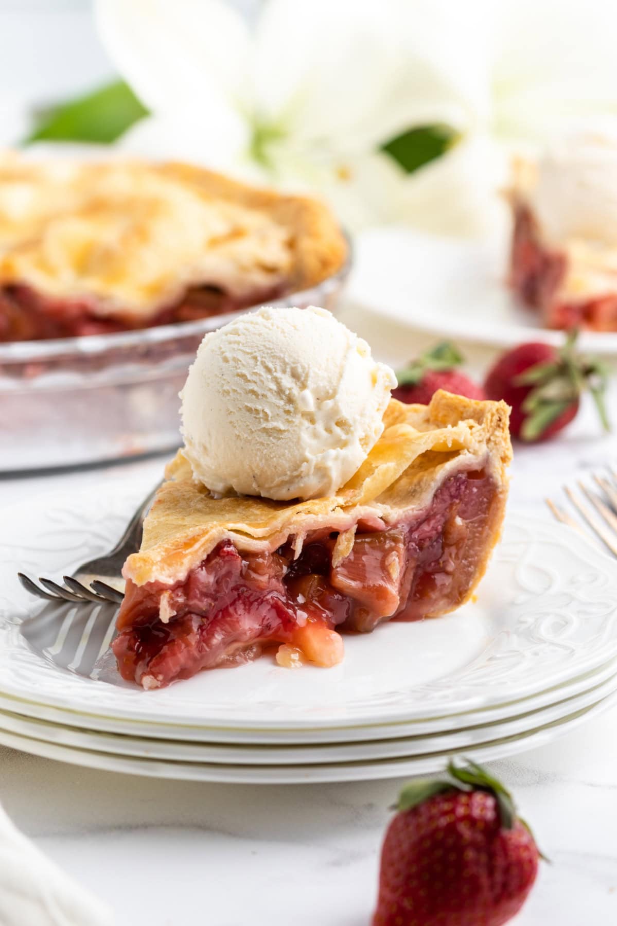 slice of strawberry rhubarb pie on a plate