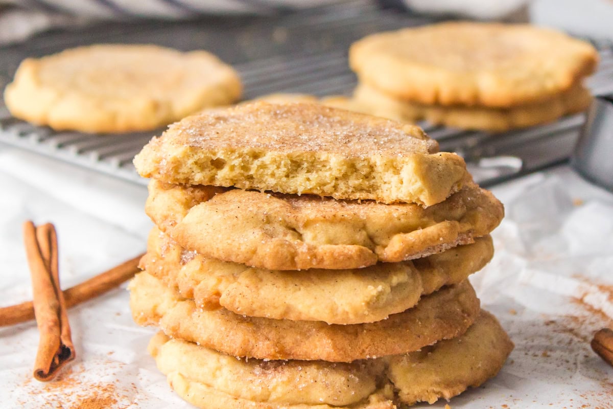 stack of sugar and cinnamon cookies with top cookie broken in half