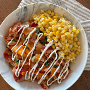 arroz con pollo in bowl with sour cream