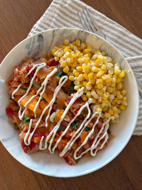 arroz con pollo in bowl with sour cream