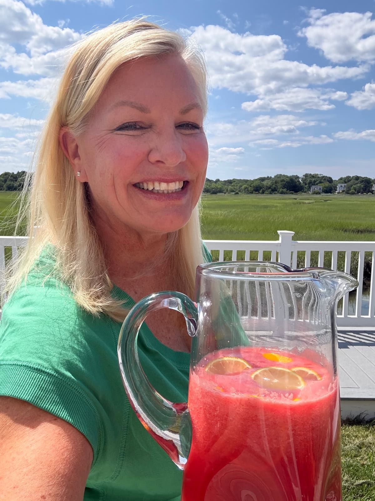 recipegirl holding pitcher of strawberry lemonade