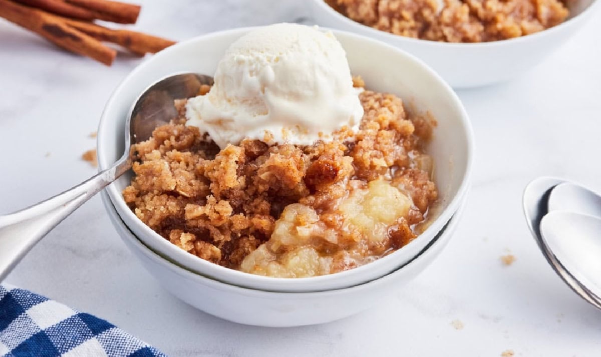 The 50 best apple recipes for fall! 🍎 Find delicious ways to use fresh apples with easy apple breads, muffins, cakes, pies, crisps, cobblers, breakfast recipes and desserts. Perfect for apple picking season, fall baking, Thanksgiving and anytime you have a big bag of apples to use. Save this collection of easy apple recipes for fall! apple betty topped with ice cream