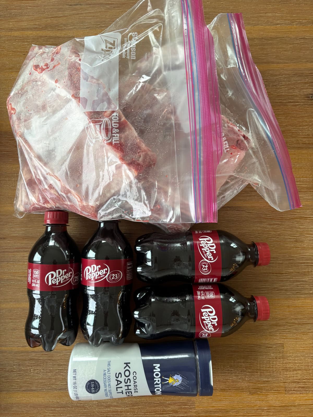 These Dr. Pepper Ribs are fall-apart tender and loaded with flavor! Baby back ribs are marinated in Dr. Pepper, baked until tender and finished on the grill with a sticky homemade Dr. Pepper BBQ sauce. An easy rib recipe for summer cookouts, Father's Day and backyard BBQs. ingredients displayed for making dr. pepper ribs
