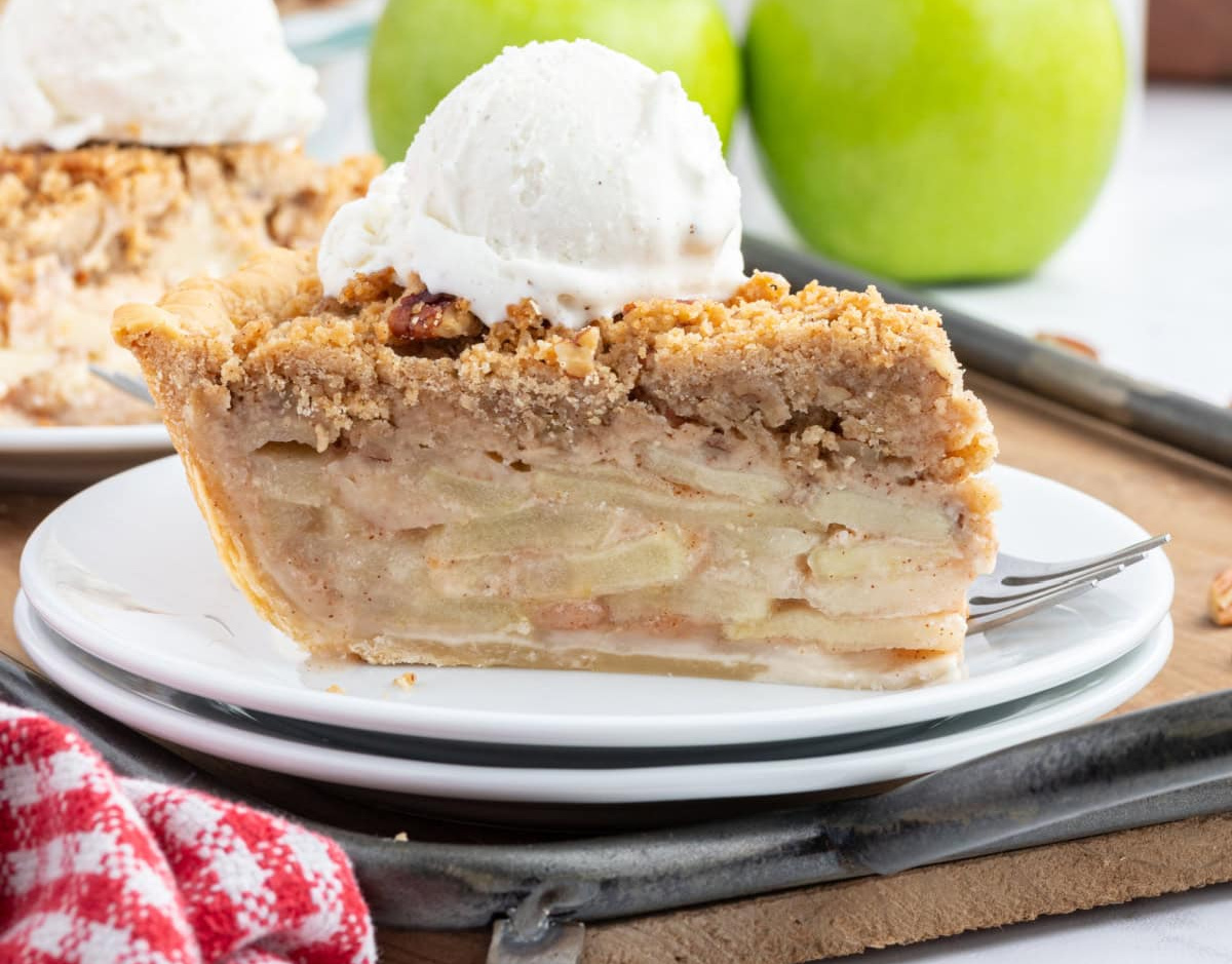 The 50 best apple recipes for fall! 🍎 Find delicious ways to use fresh apples with easy apple breads, muffins, cakes, pies, crisps, cobblers, breakfast recipes and desserts. Perfect for apple picking season, fall baking, Thanksgiving and anytime you have a big bag of apples to use. Save this collection of easy apple recipes for fall! slice of dutch apple pie