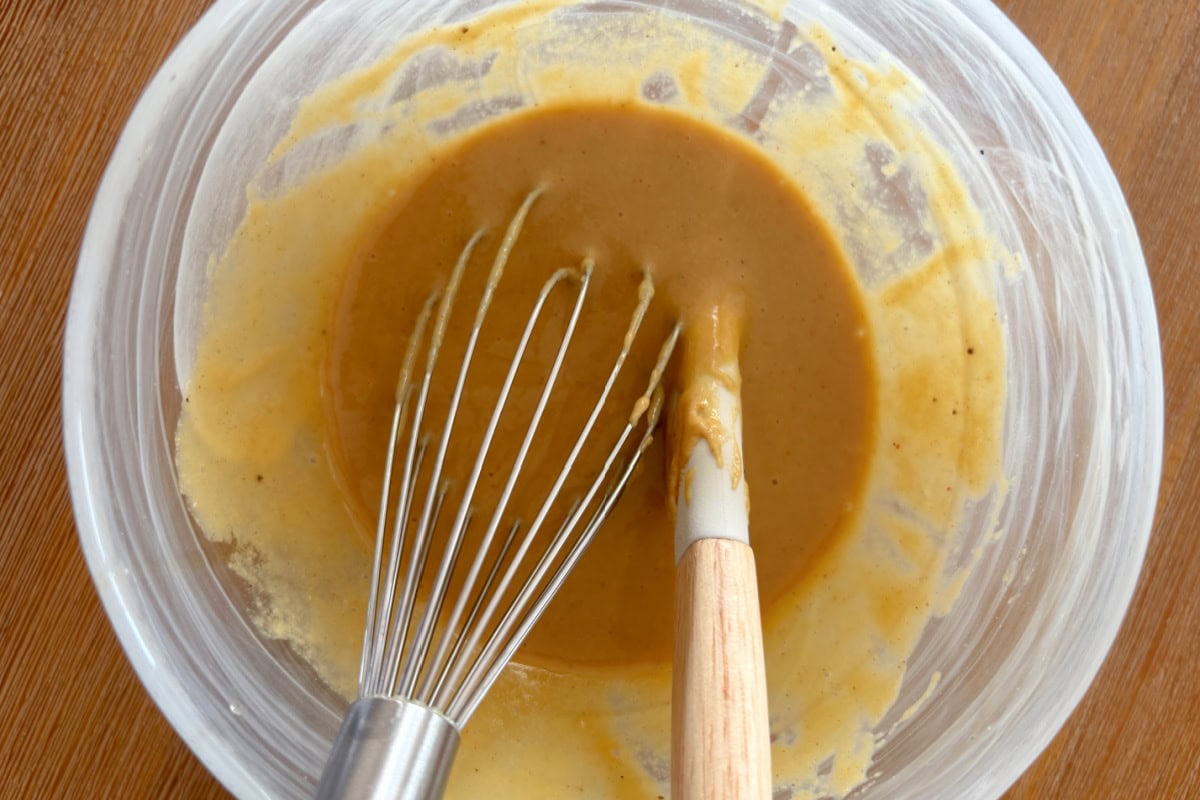 This Maple Mustard Salmon is one of the easiest salmon dinners you'll ever make! 🍁 Made with Dijon mustard, pure maple syrup and garlic, it's sweet, savory, flaky and perfect for busy weeknights or entertaining. Save this easy baked salmon recipe! #salmon #salmonrecipe #healthydinner #weeknightdinner #seafood maple mustard sauce i bowl with whisk