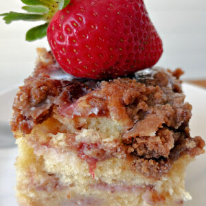 slice of strawberry coffee cake with fresh strawberry on top