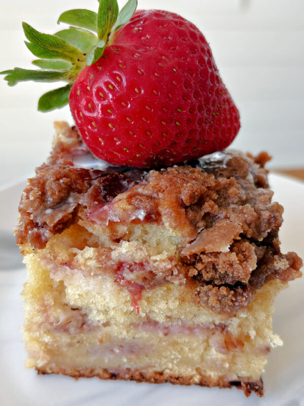 slice of strawberry coffee cake with fresh strawberry on top