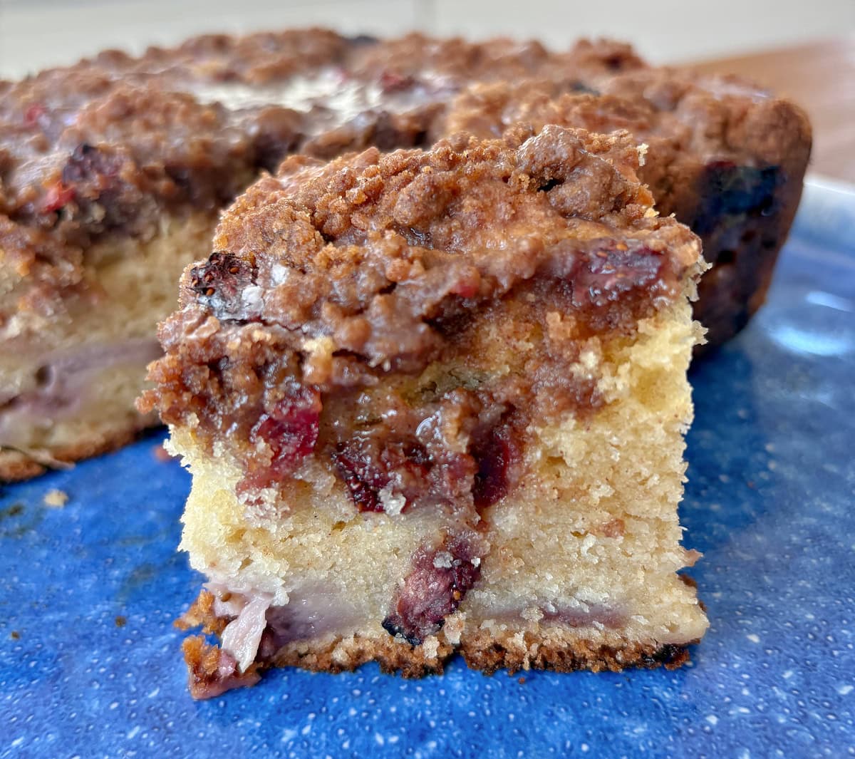 slice of strawberry coffee cake on blue platter