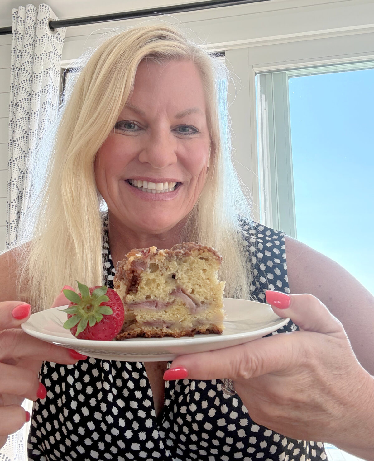 recipegirl holding slice of strawberry coffee cake