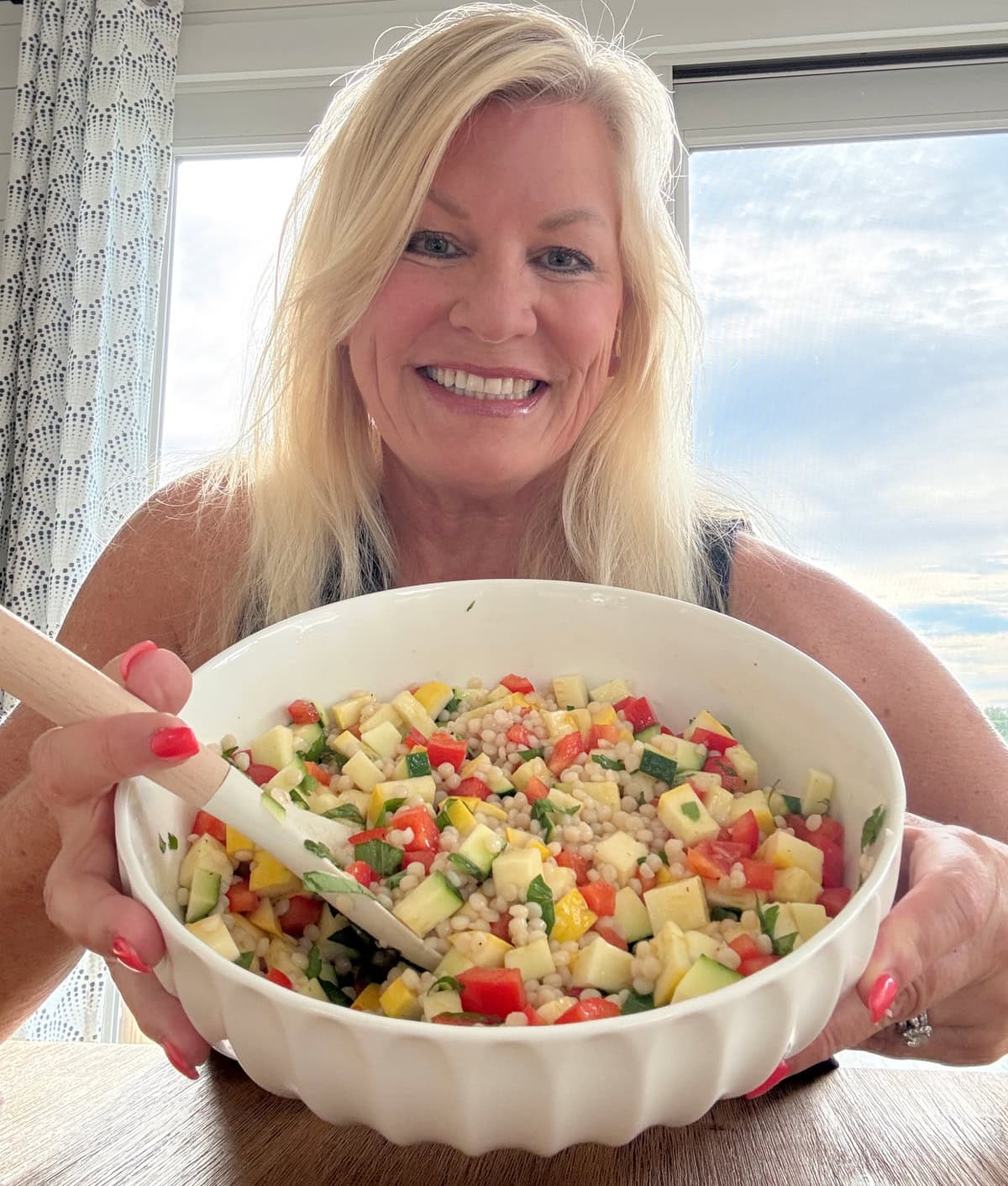 recipegirl holding bowl of summer couscous salad