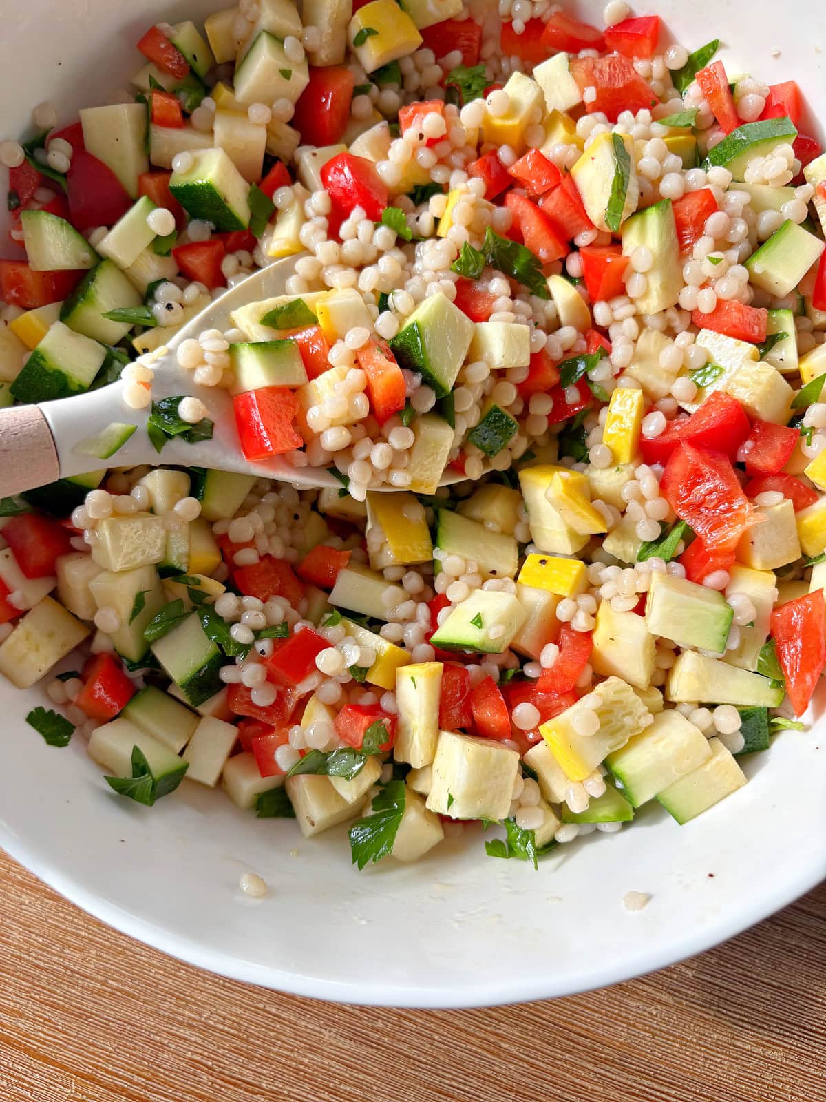 bowl of summer couscous salad with a spoon