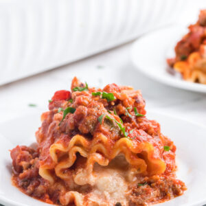 one Italian Sausage Lasagna Roll Ups on a plate