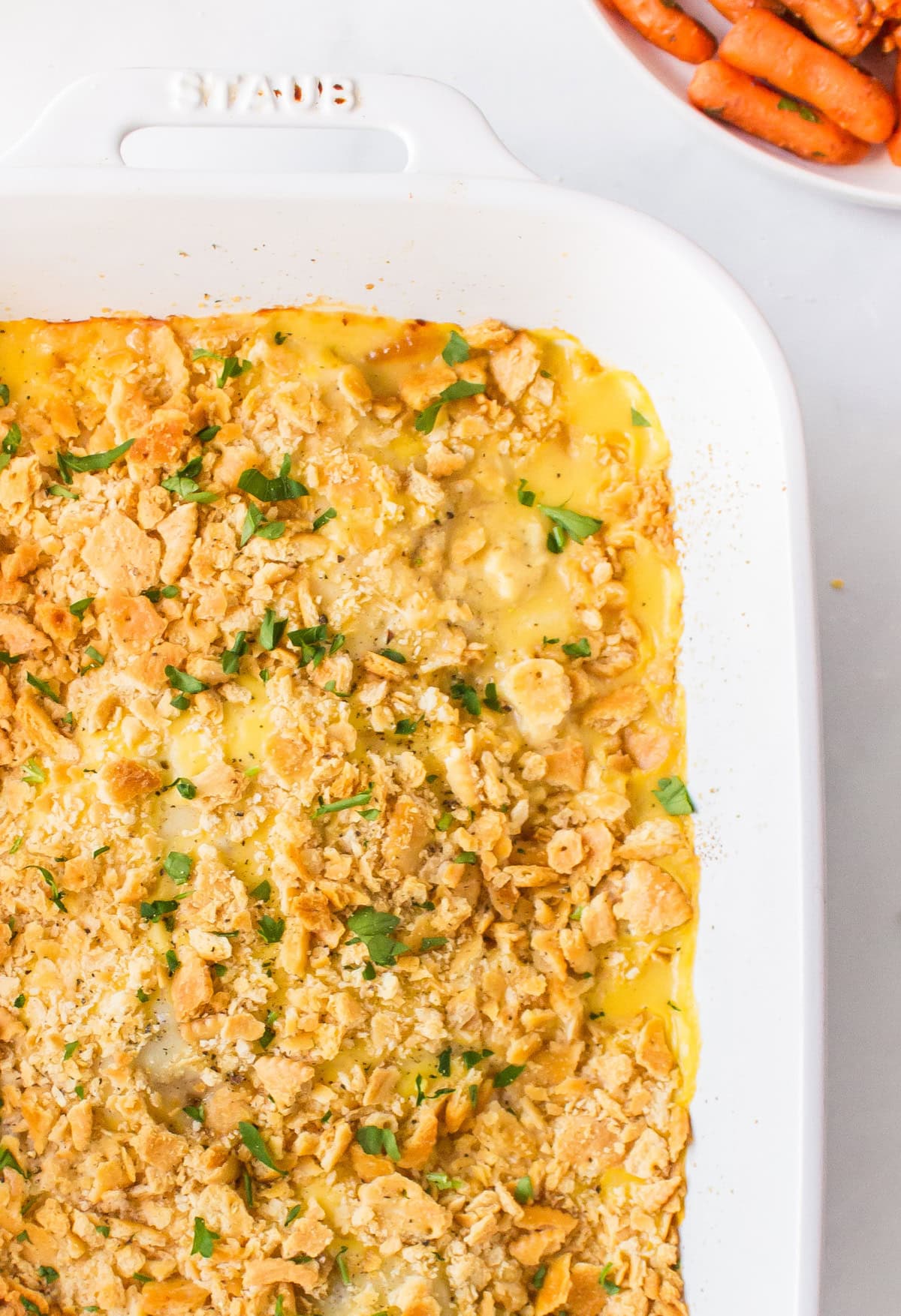 This easy Swiss Cheese Chicken recipe is the perfect comfort-food dinner! Chicken breasts are topped with Swiss cheese, a creamy sauce and buttery Ritz cracker crumbs, then baked until tender and golden. An easy 45-minute chicken dinner that's great for busy weeknights. swiss cheese chicken in casserole dish