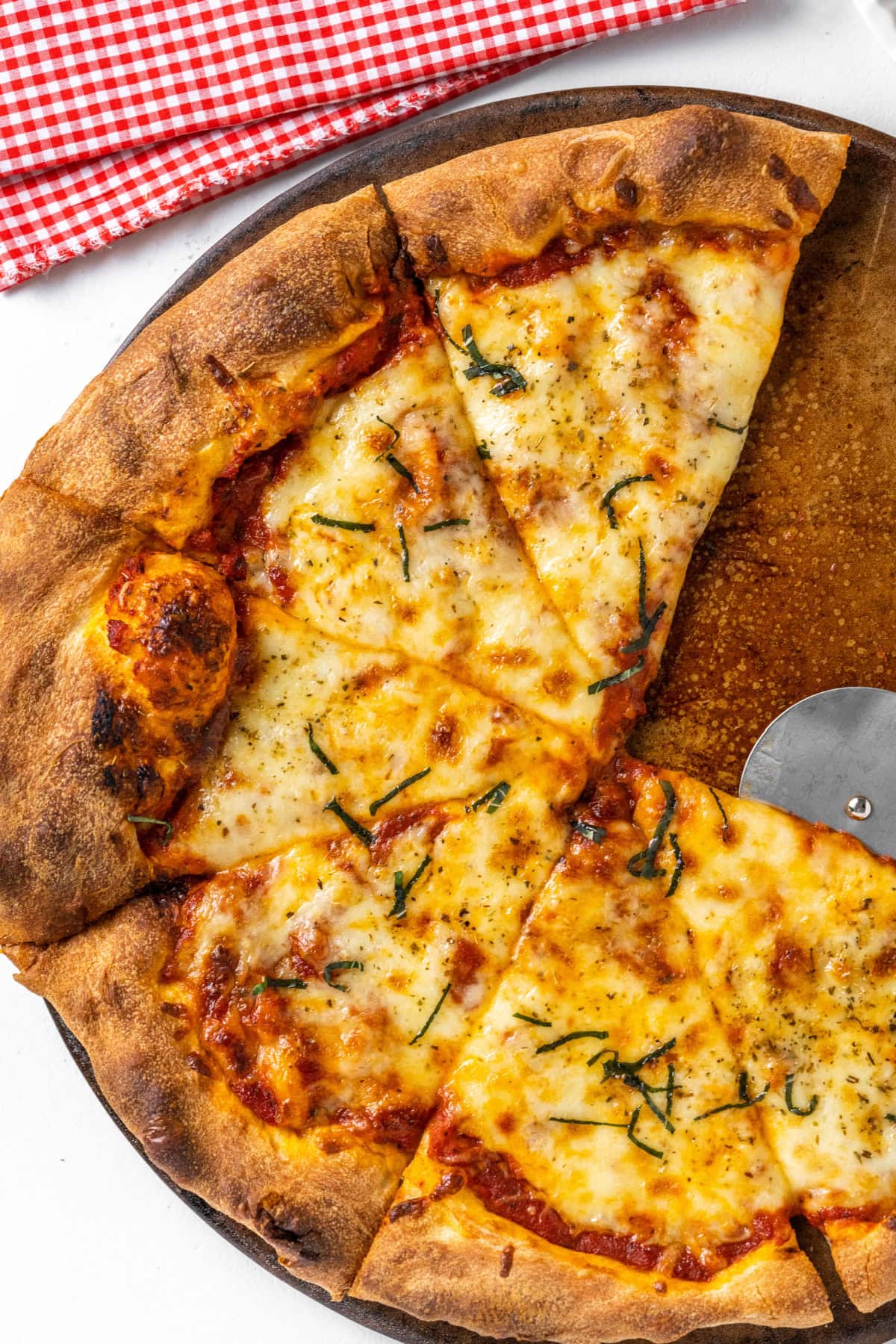 cheese pizza with a couple slices taken out of it