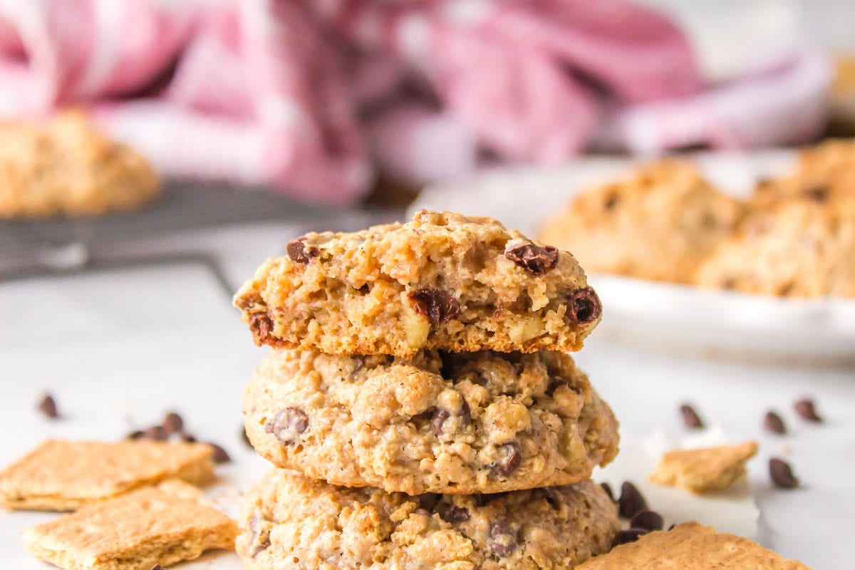 three cookies stacked with one on top bite taken out